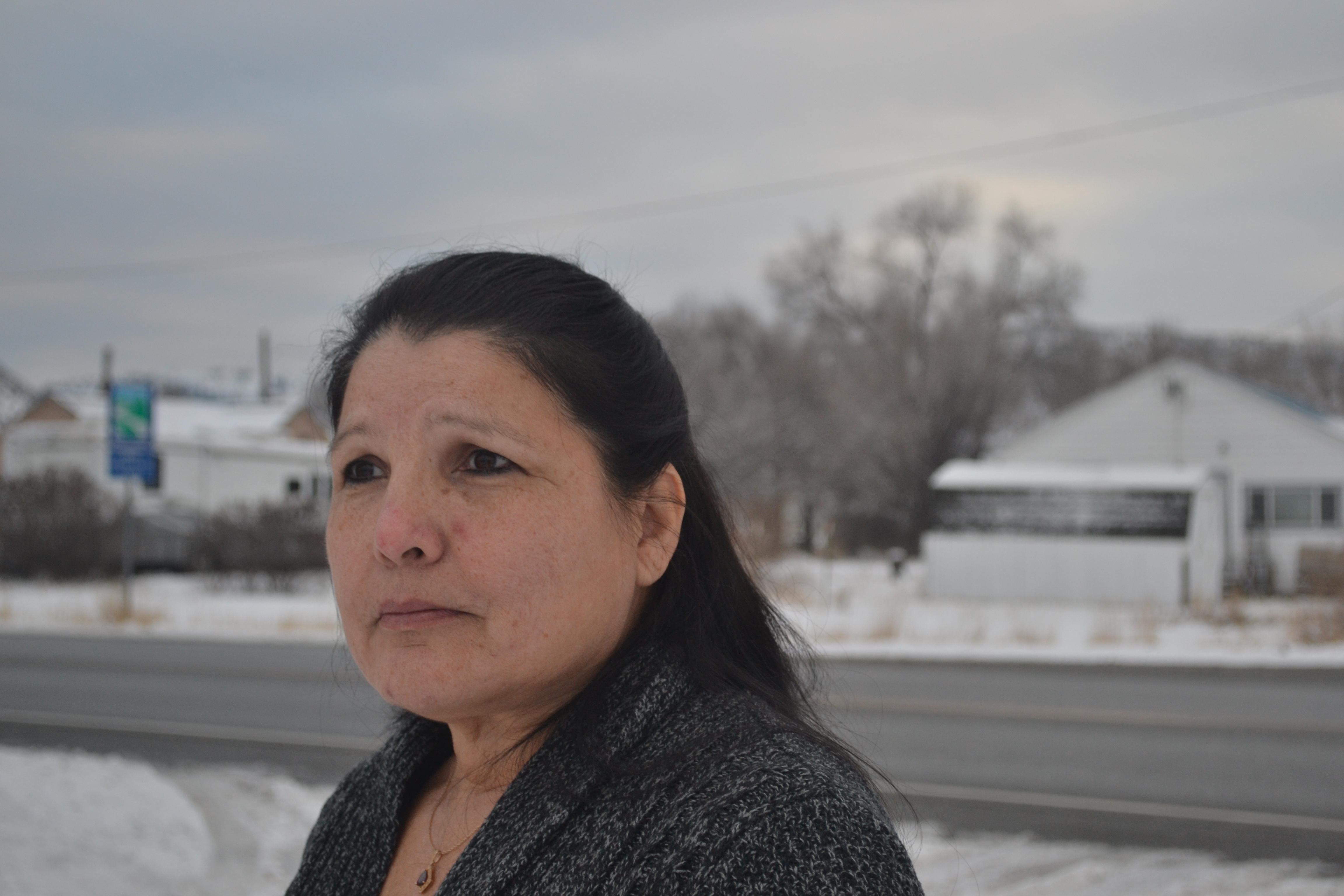 Norma Sanchez stands outside, near a highway