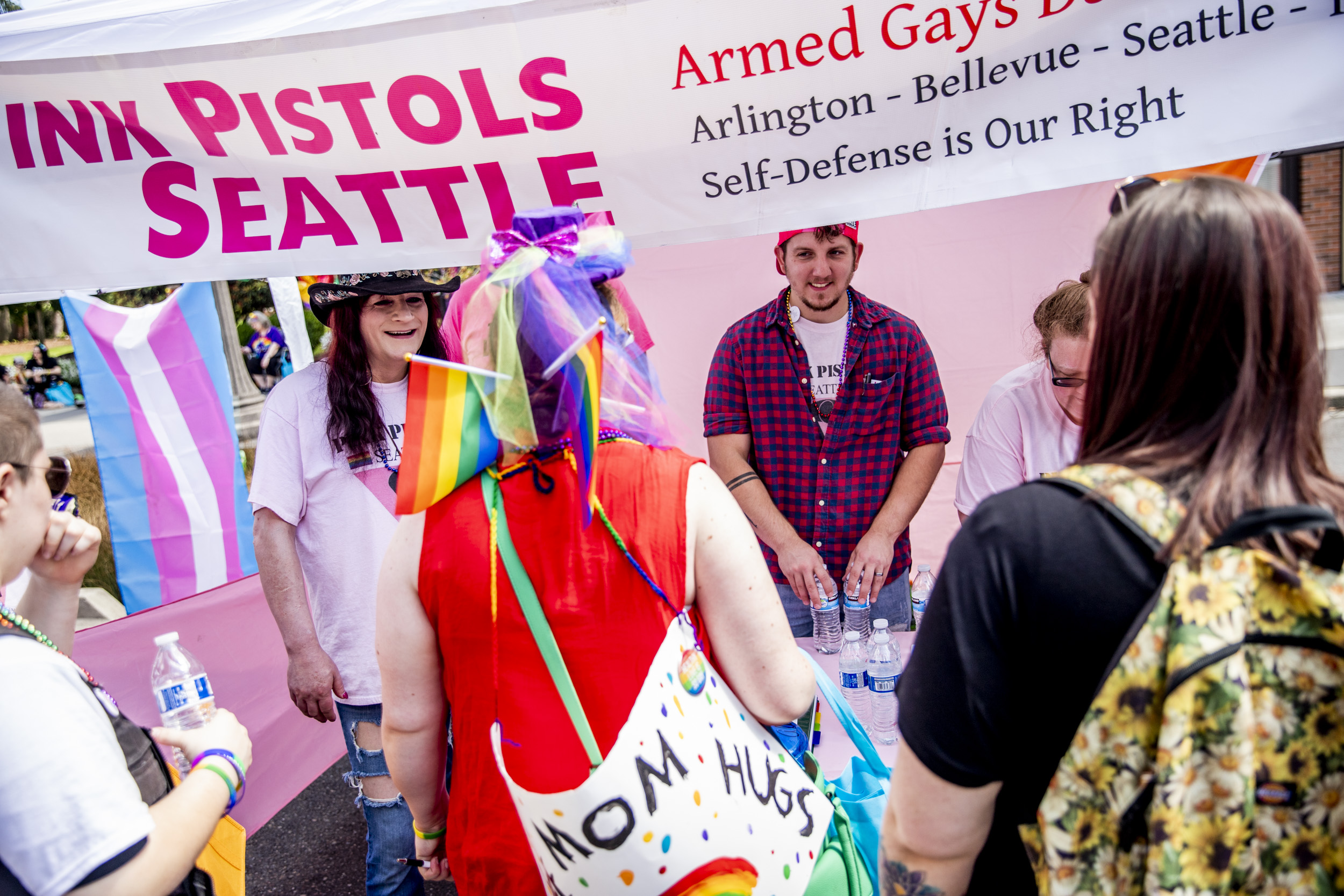 Pink Pistols members talk to attendees during Tacoma Pride on July 13, 2019. Pink Pistols Seattle administrator Sharyn Hinchcliffe says she has noticed more interest in Pink Pistols since the Pulse night club shooting in June 2016 and the election of President Trump. “I would say the increase in inquiries that we get and new people actually showing up - definitely there has been [an increase]. We do definitely see it. This is our third year doing pride in the region,” Hinchcliffe says. (Photo by Dorothy Edwards/Crosscut)