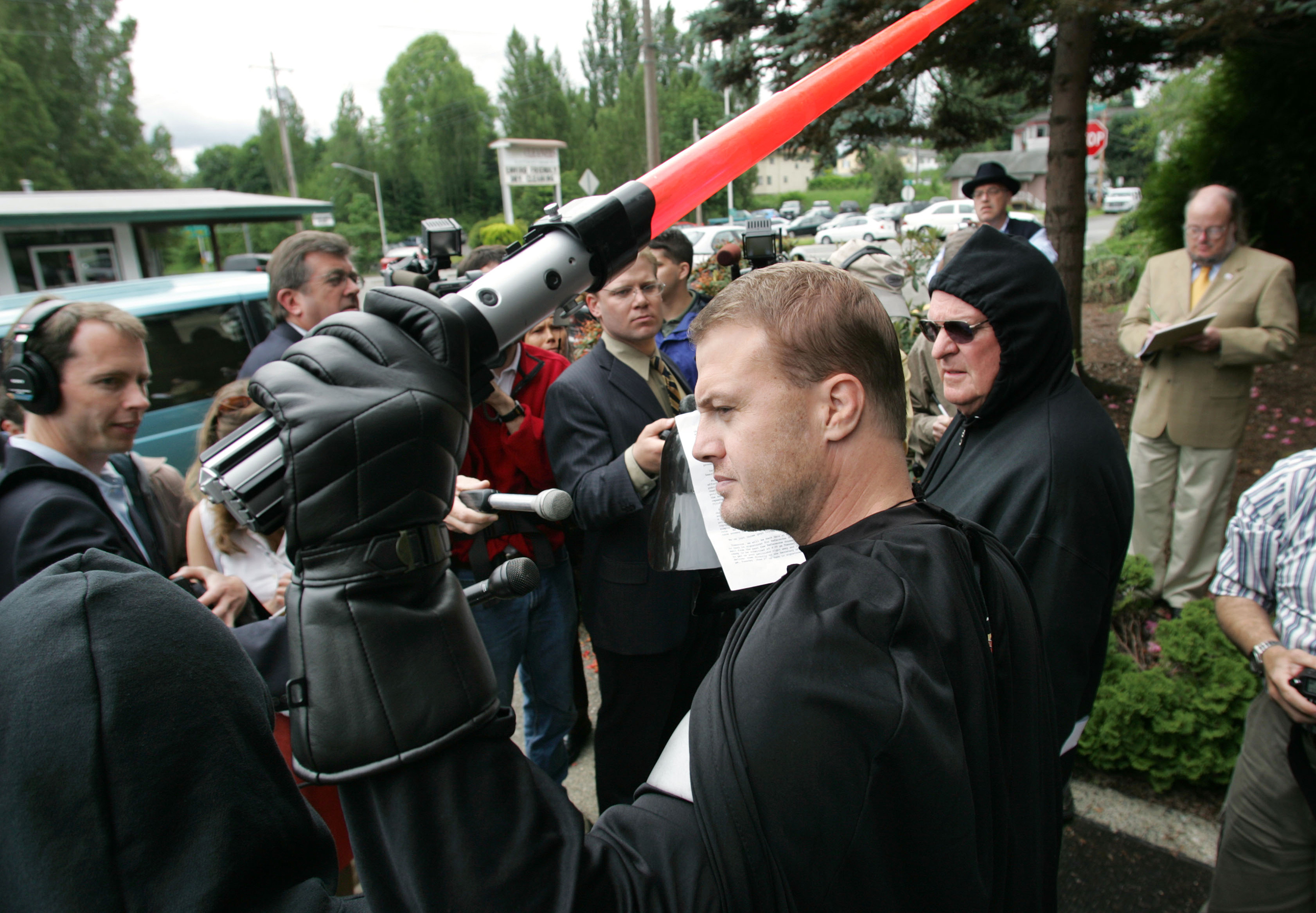 Tim Eyman, dressed as Darth Vader, holding a plastic light saber 