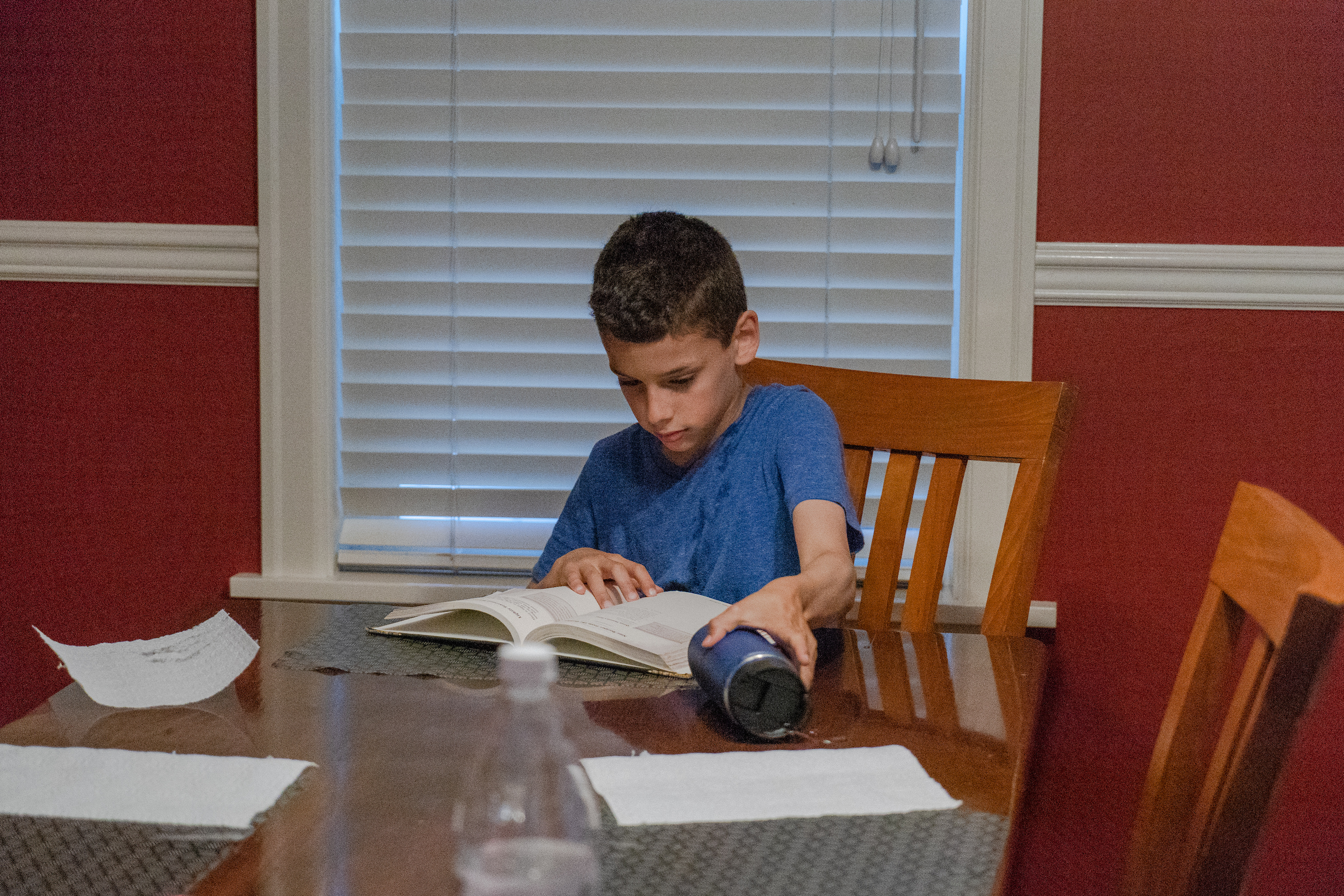 Kienan Ellis, 10, reads before dinner at his family's home in Seattle.