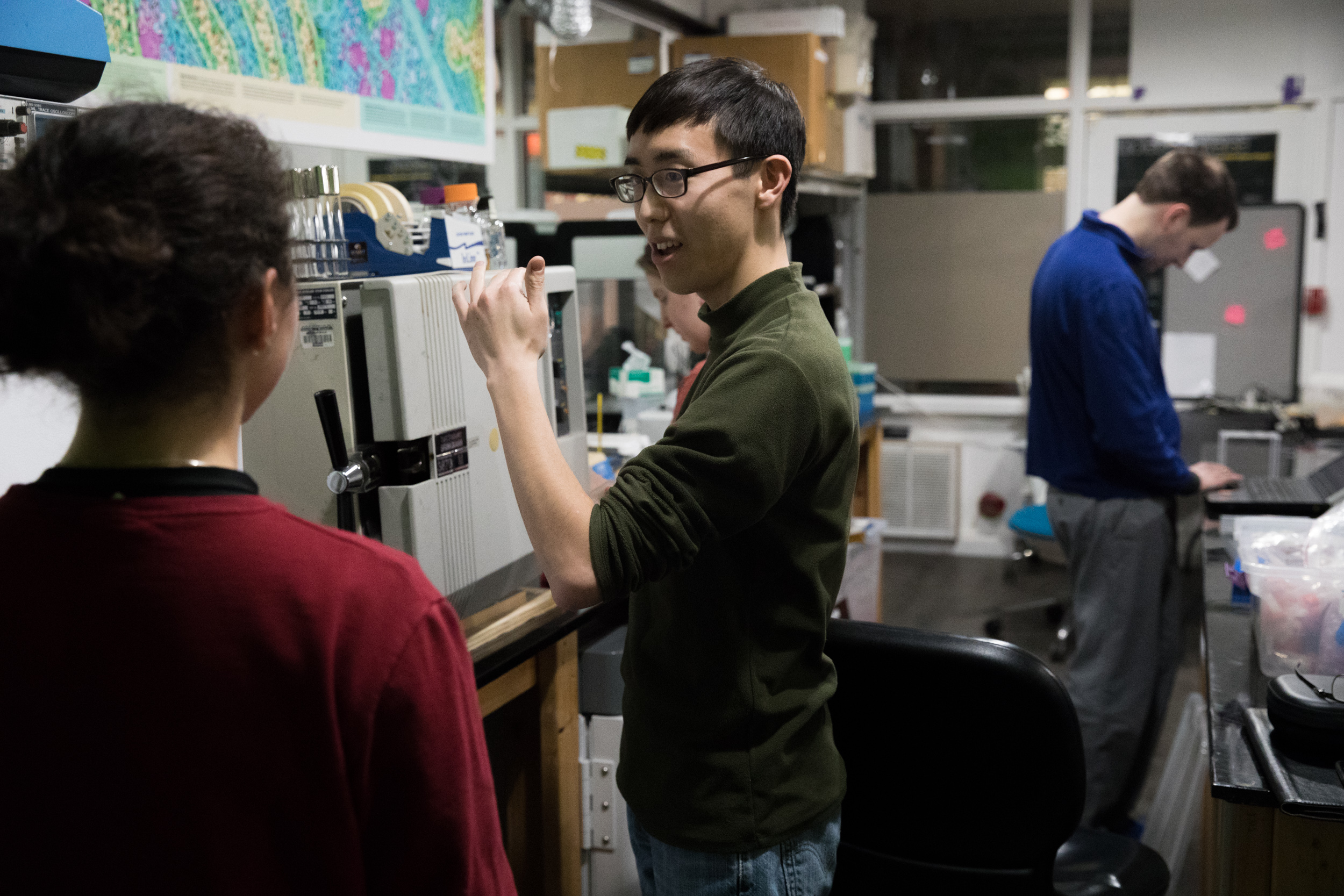 Yoshi Goto speaks with high school student Sienna Patton during a group meeting at Sound Bio Lab in Seattle's University District.