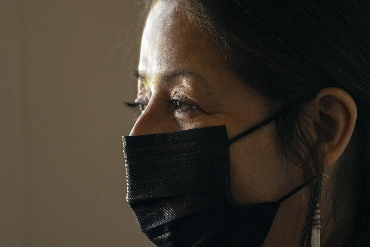 A closeup of a woman wearing a face mask