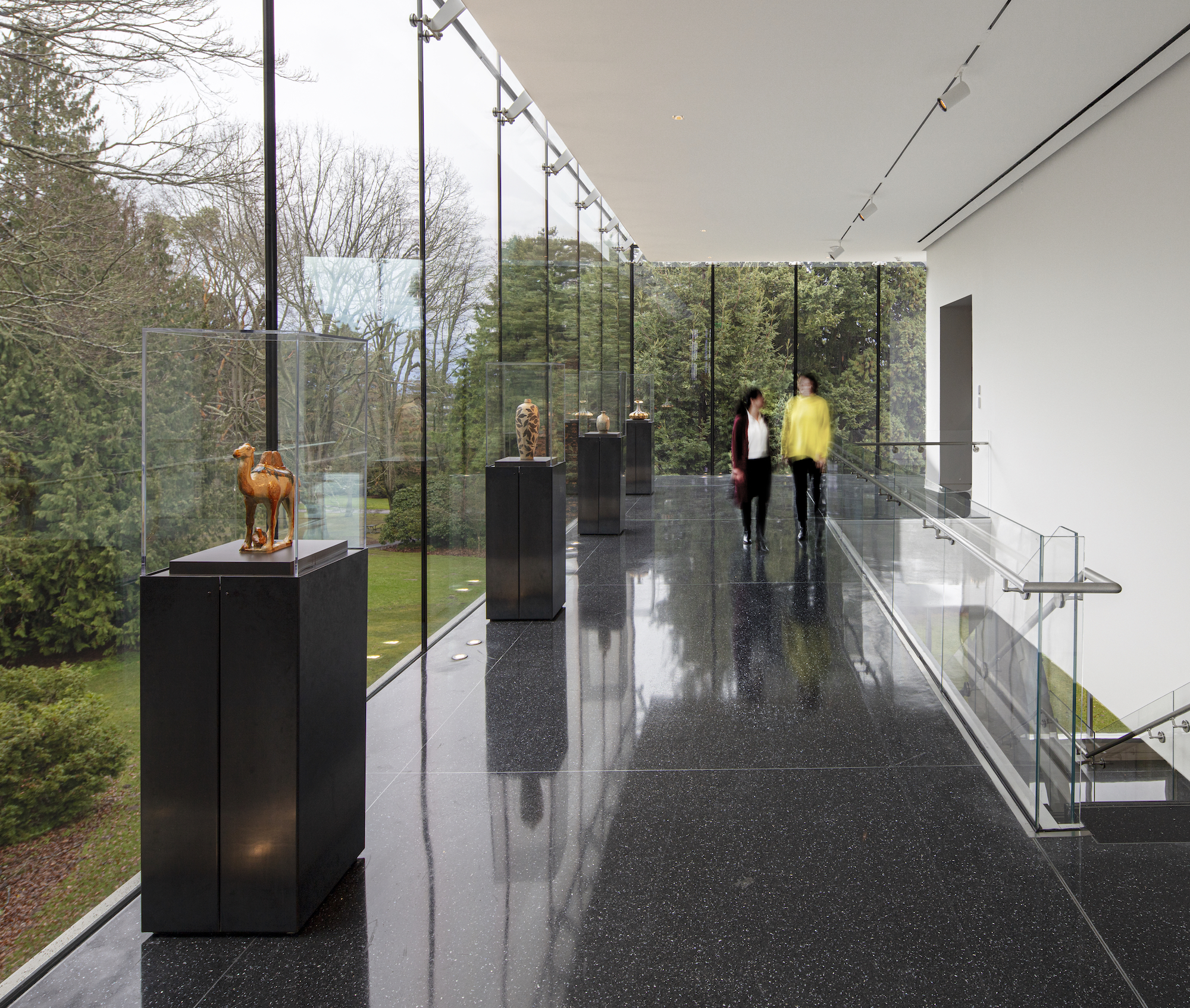 a glass lobby with art objects