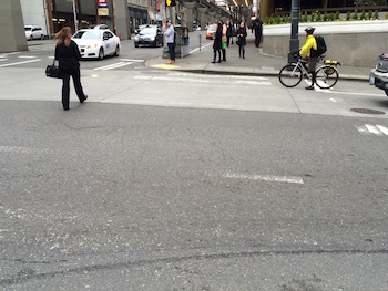 This crosswalk downtown is like many in the city, where pedestrian safety markings are little more than a memory. (Photo by Douglas MacDonald for Crosscut)