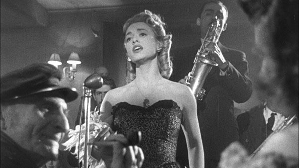 black and white film still with a chanteuse