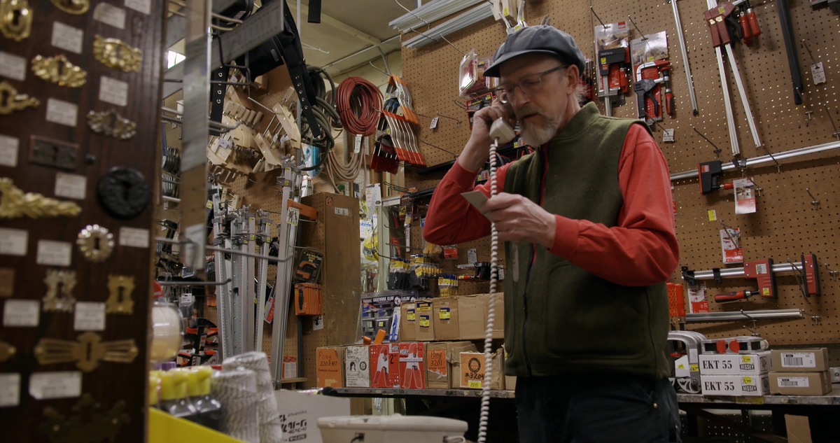 Man picks up the phone in hardware store