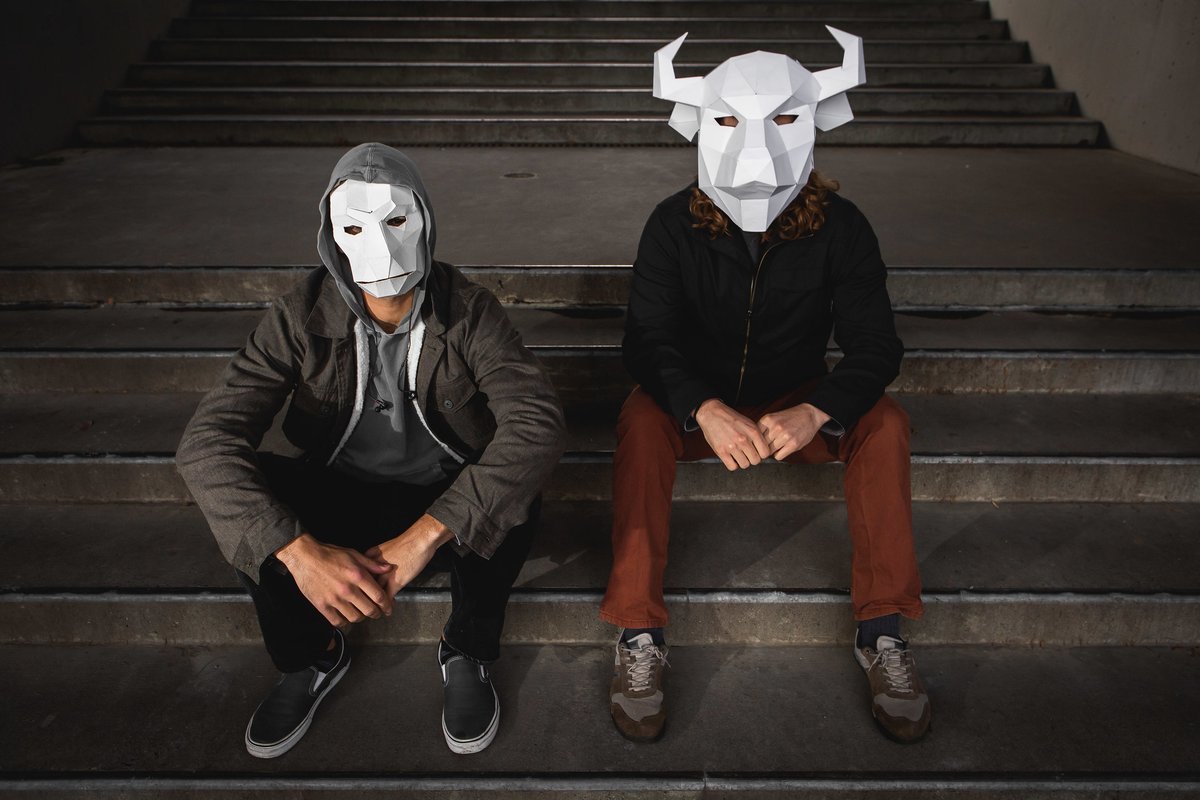 two band members in paper masks