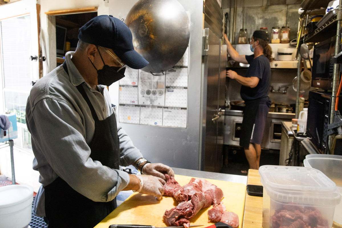 Wali Khairzada, owner of Kabul Restaurant in Seattle’s Wallingford neighborhood, slices beef for one of the many traditional Afghan dishes that his restaurant serves.