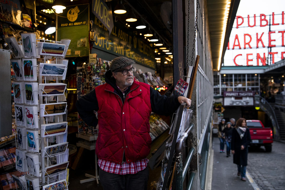 Lauckhart at his newstand with Pike Place sign in background