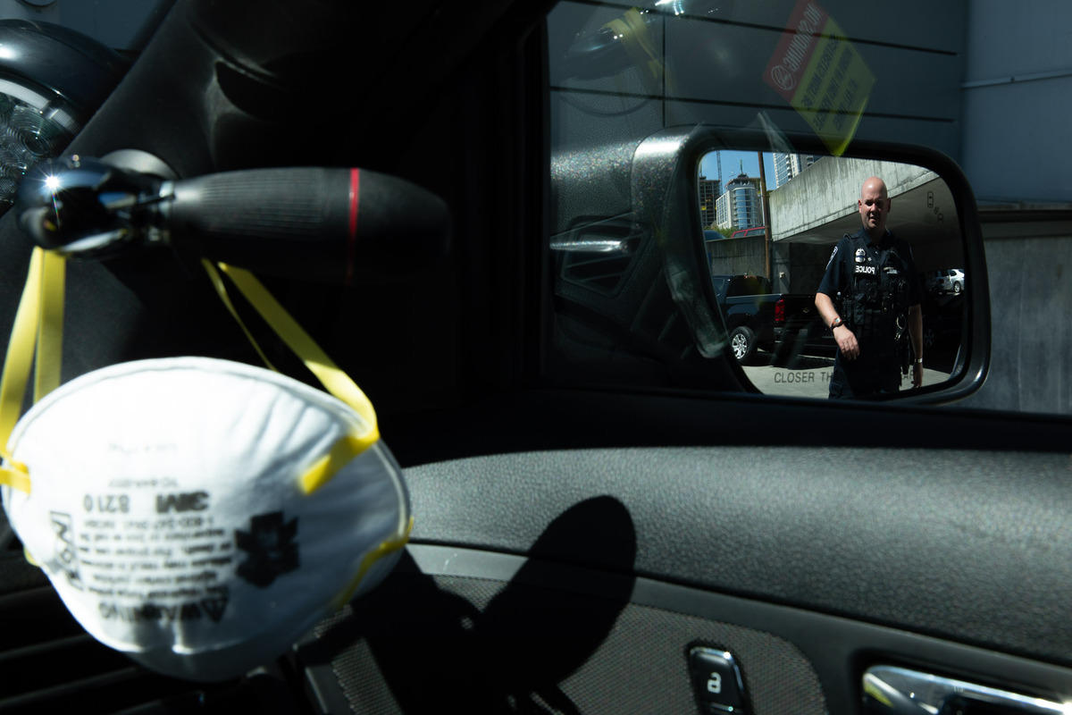 A police officer seen in a side view mirror