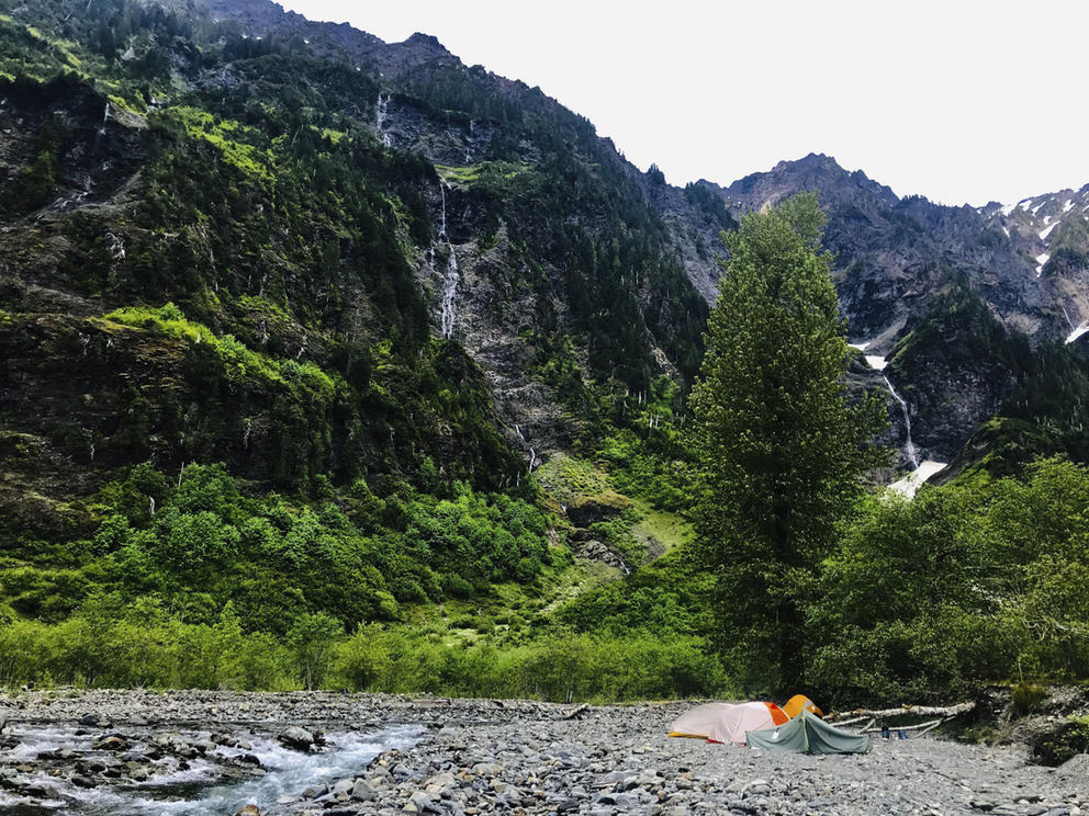 tents along a mountain stream