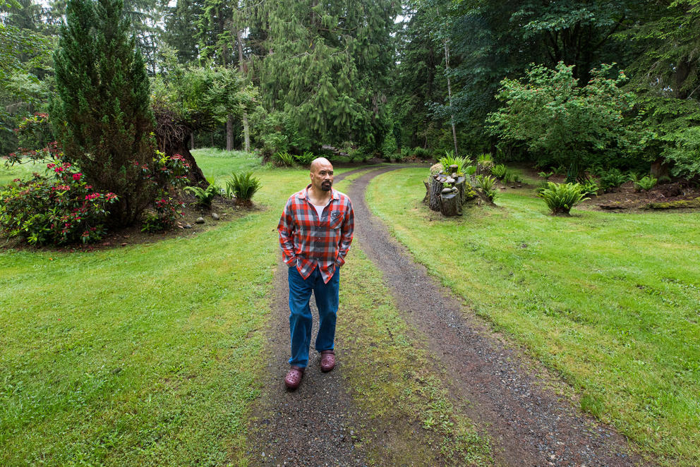 Man walks on a path surrounded by greenery