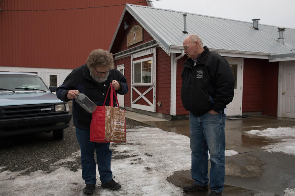 Crosscut columnist Knute Berger returns empty milk bottles to owner Larry Stap of Twin Brook Creamery near Lynden, Washington. 