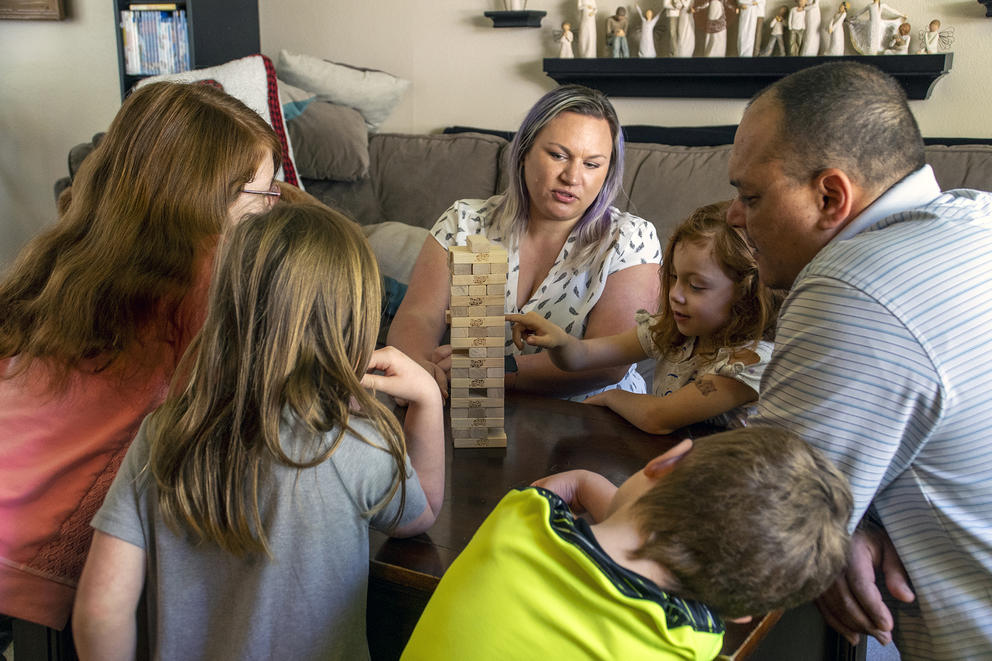 A family plays a stacking game