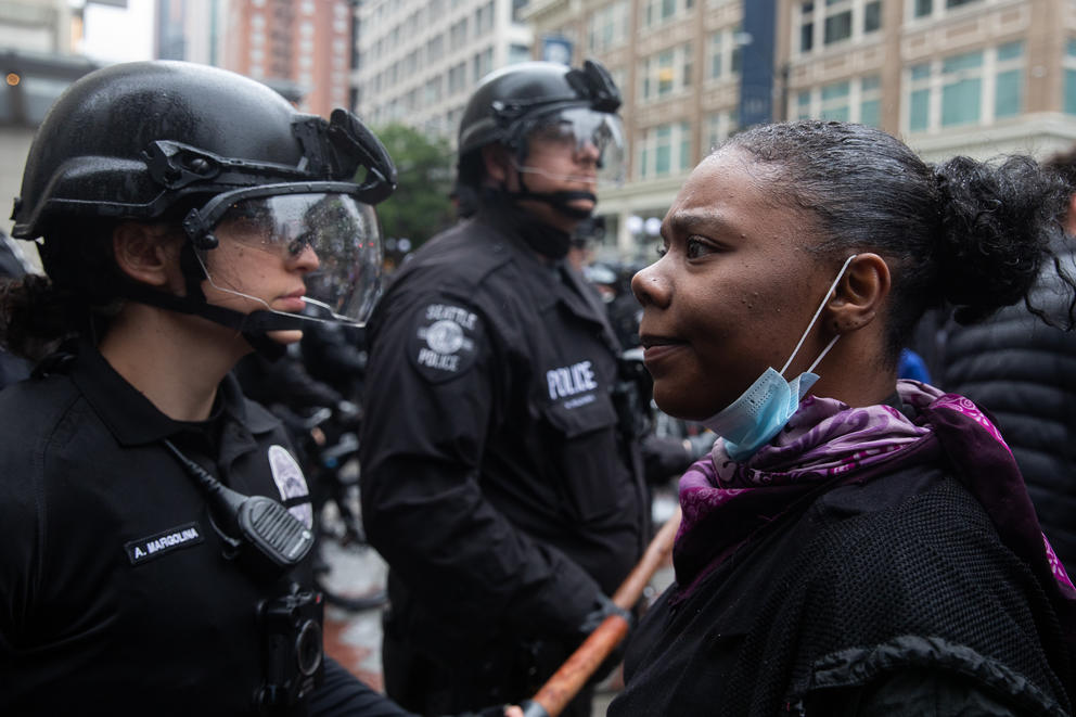 A woman stares at a police officer