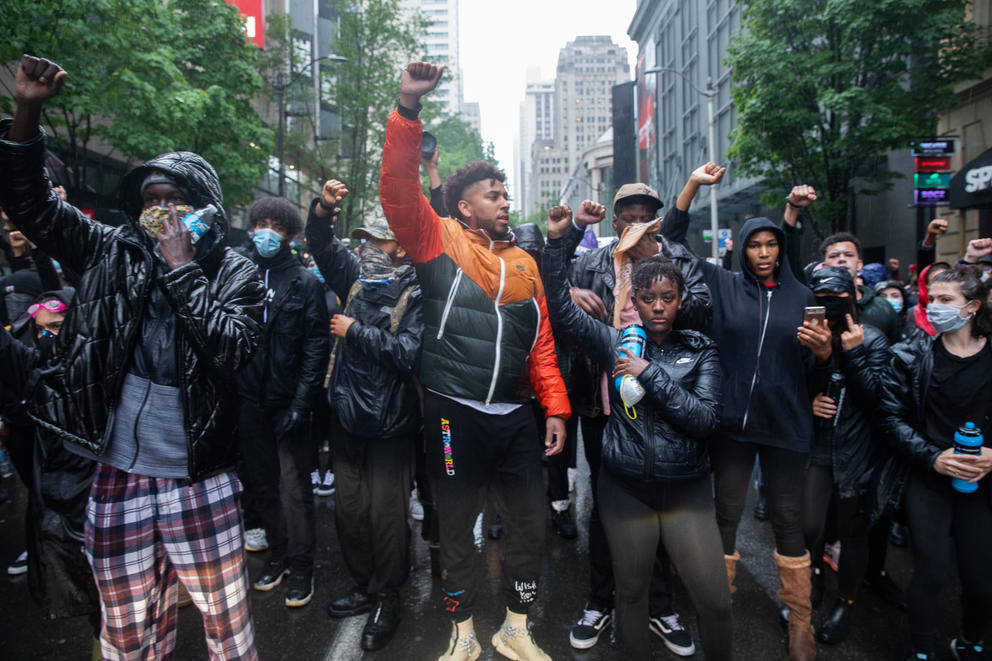 Demonstrators span the width of a Seattle street with their fists in the air. They were chanting "Say his name, George Floyd" during protests on May 30, 2020.
