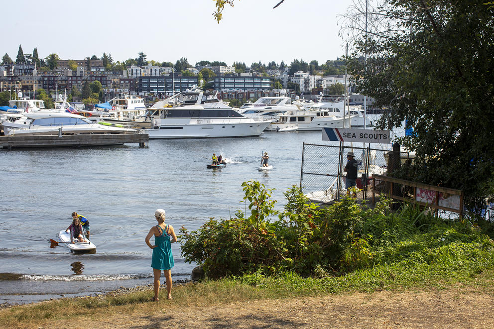 Alisa McKenzie watches her cousins from the shore of Waterway 18, as they play in Lake Union.