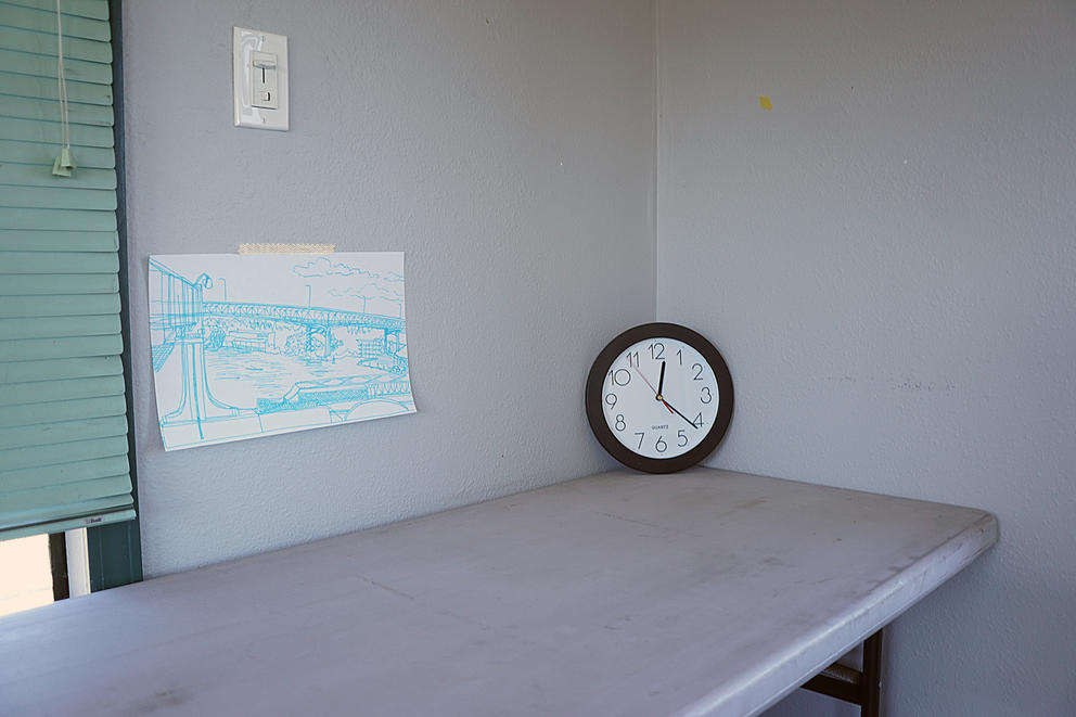 A clock sits in the corner with an illustration of a bridge