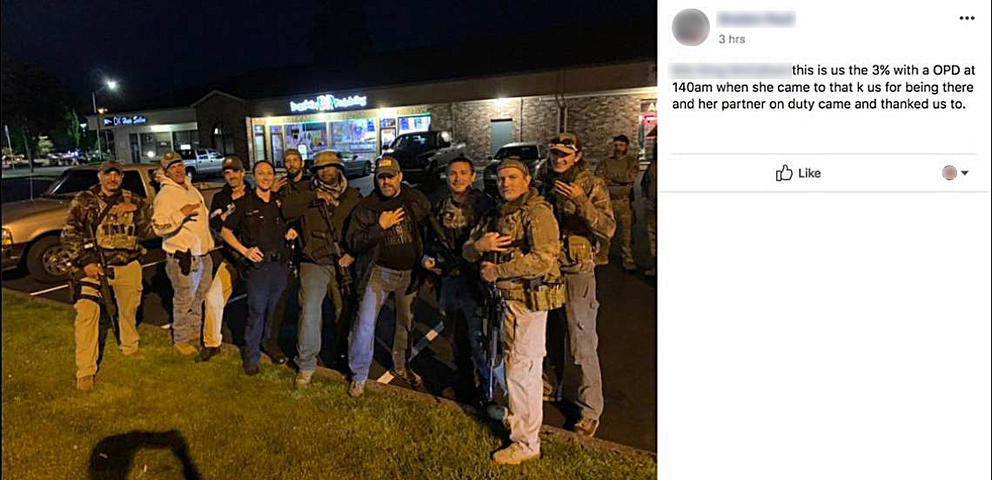 post from Facebook of officer with armed men