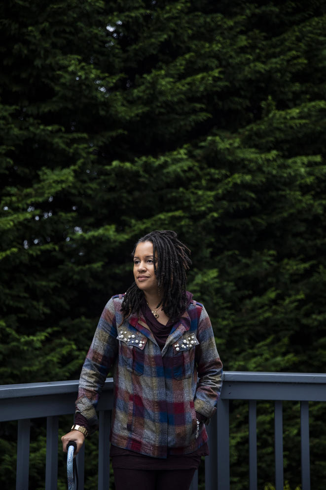 April Berg stands on a deck with trees in background