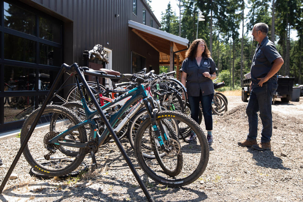 A line of bikes, with Heidi and Kelly Campo standing to the side