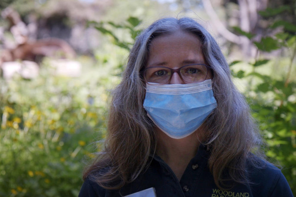 Animal keeper Susan Burchardt stands in front of the bear habitat at Woodland Park Zoo on May 27, 2020. Among other critters, Burchardt takes care of zoo's two grizzly bears.