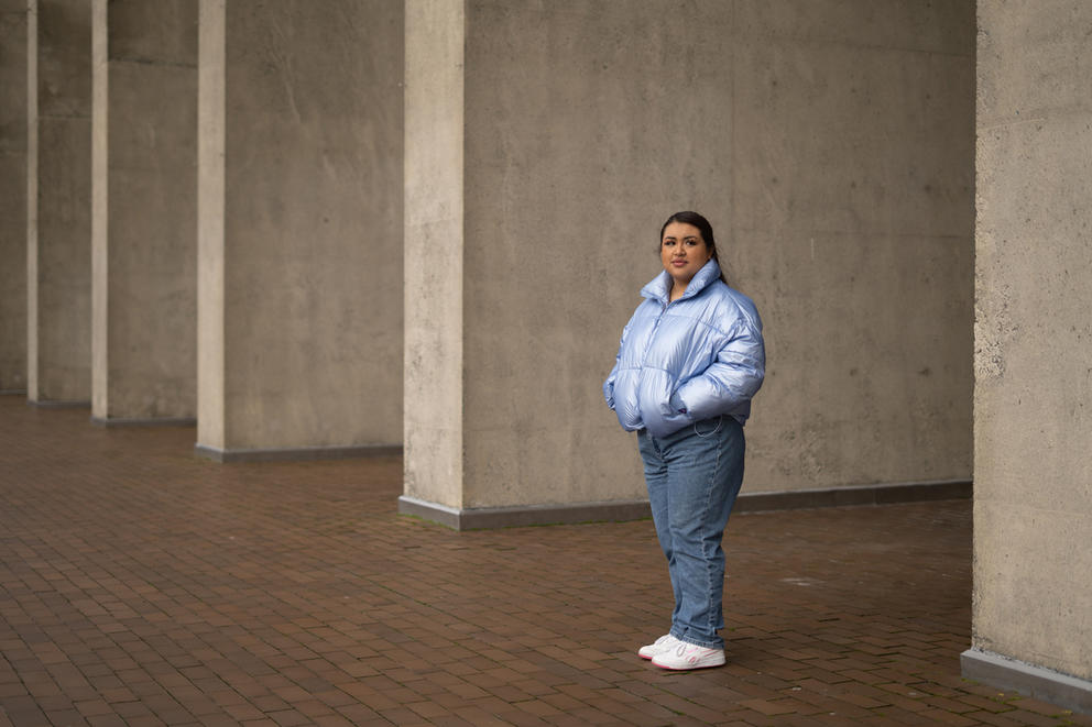 Abril M. Rodriguez stands framed between concrete pillars 