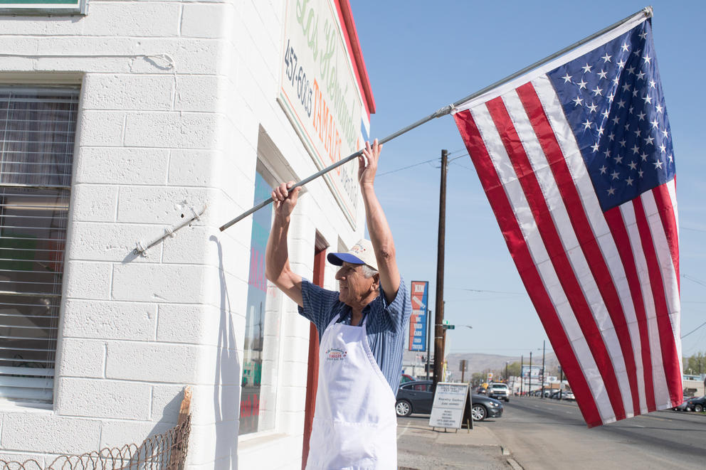 Owner Felipe Hernández hangs an American flag on the exterior of Los Hernández Tamales in Union Gap, Washington, opening the small, award-winning restaurant for yet another day. 