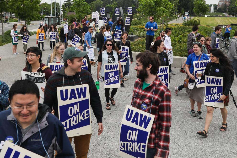 People gathered at the corner of Montlake Boulevard NE and NE Pacific Street during a one-day strike with graduate students who are represented by UAW Local 421 at the University of Washington in Seattle, May 14, 2018.