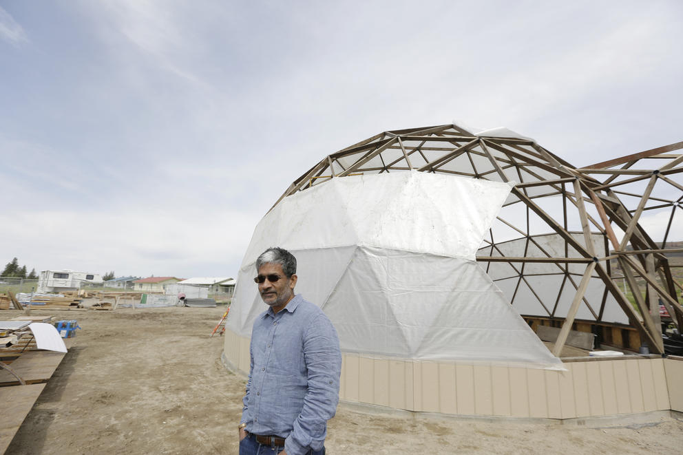 Sanjay Rajan stands outside the under-construction geodesic dome on the Colvile Reservation