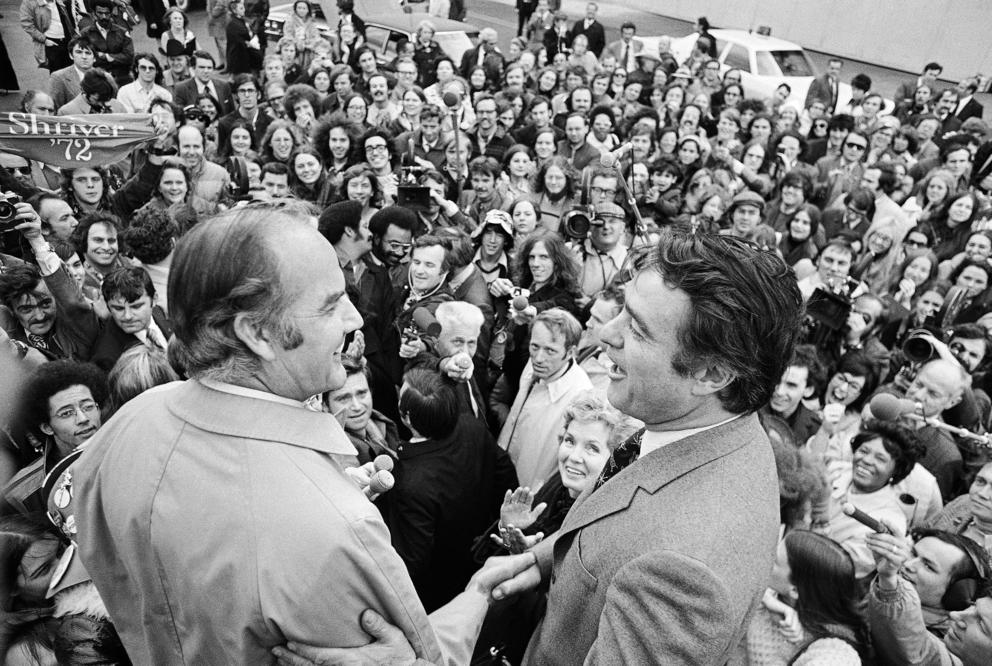 Two politicians address a crowd of supporters