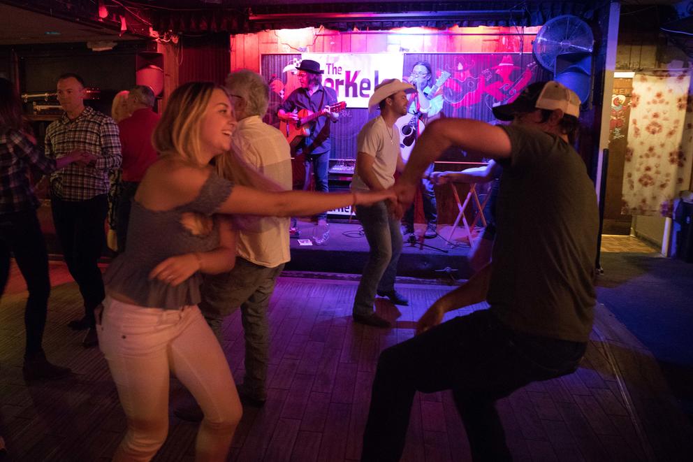 A woman dances with former bartender turned patron Jonathan Gubbe at Little Red Hen.