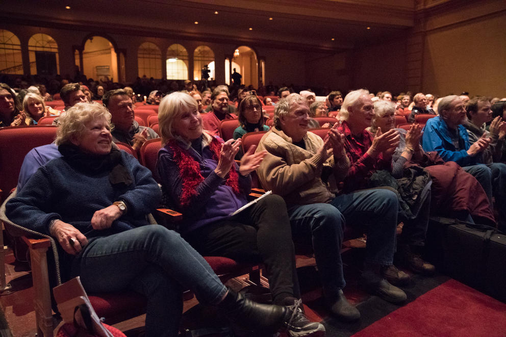 A crowd cheers during a Fisher Poet's Gathering performance at the near century-old Liberty Theatre in Astoria. 
