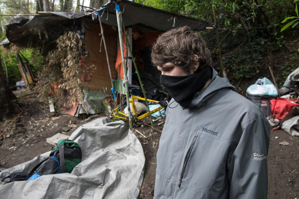 Resident Charlie Blackwood stands outside of a structure during a sweep of Ravenna Woods homeless encampment near Seattle's University Village neighborhood, Tuesday, April 17.