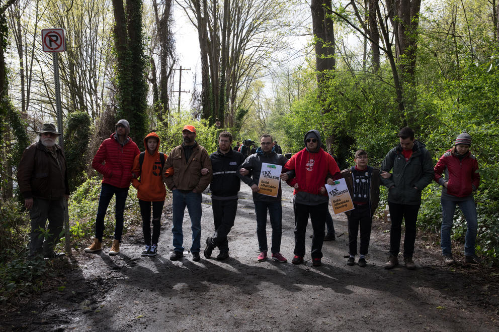 Protesters gathered on an access road to prevent Seattle Police Department from entering, during a sweep of  Ravenna Woods homeless encampment near Seattle's University Village neighborhood, Tuesday, April 17.