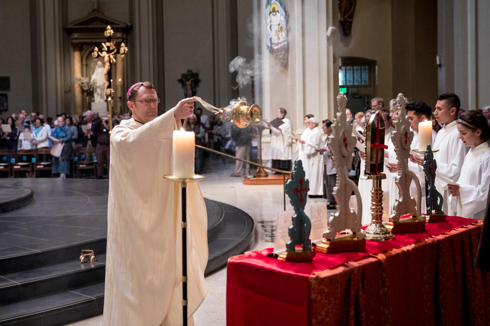 Archdiocese of Seattle’s Auxiliary Bishop Msgr. Daniel H. Mueggenborg burns incense at St. James Cathedral in Seattle. 