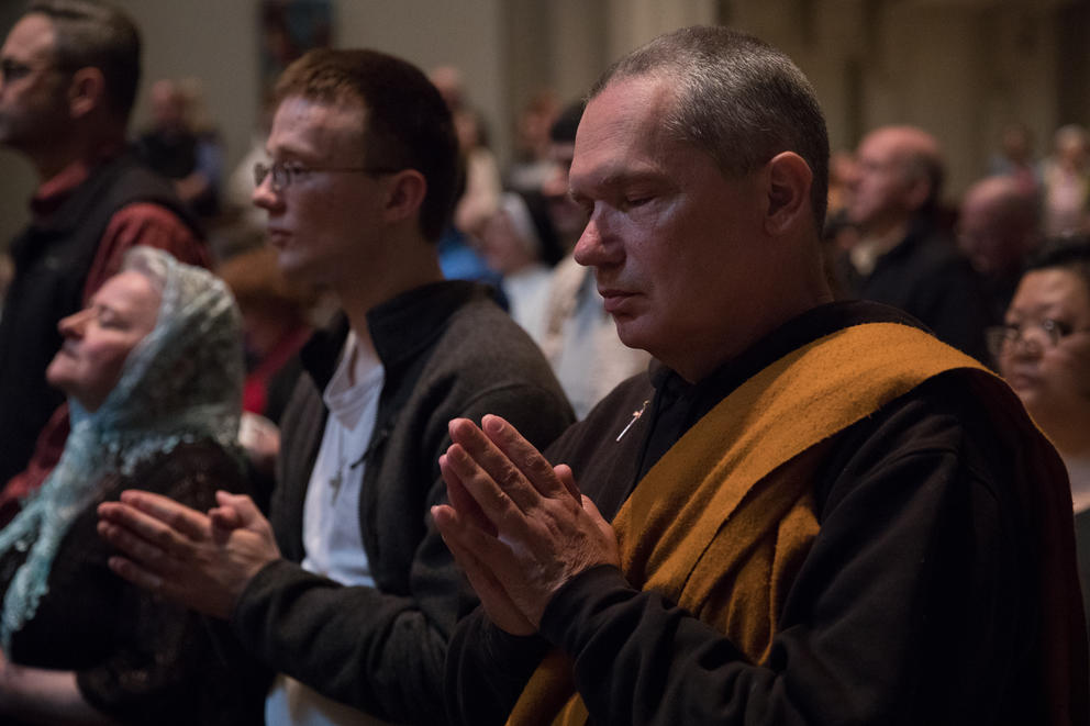 During the Mass at St. James Cathedral, various parishioners closed their eyes in prayer.