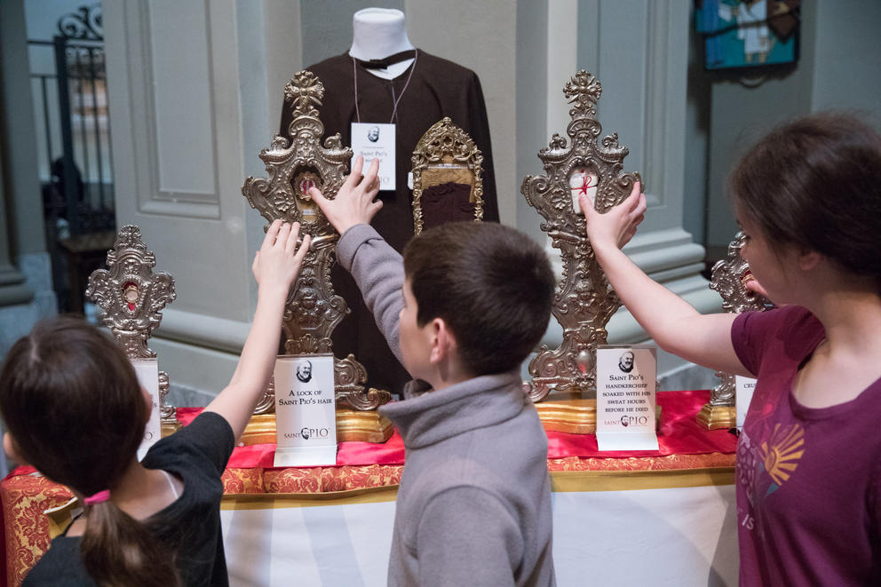 Children visiting St. James Cathedral in Seattle were granted an opportunity to touch Padre Pio's relics during the public veneration. 