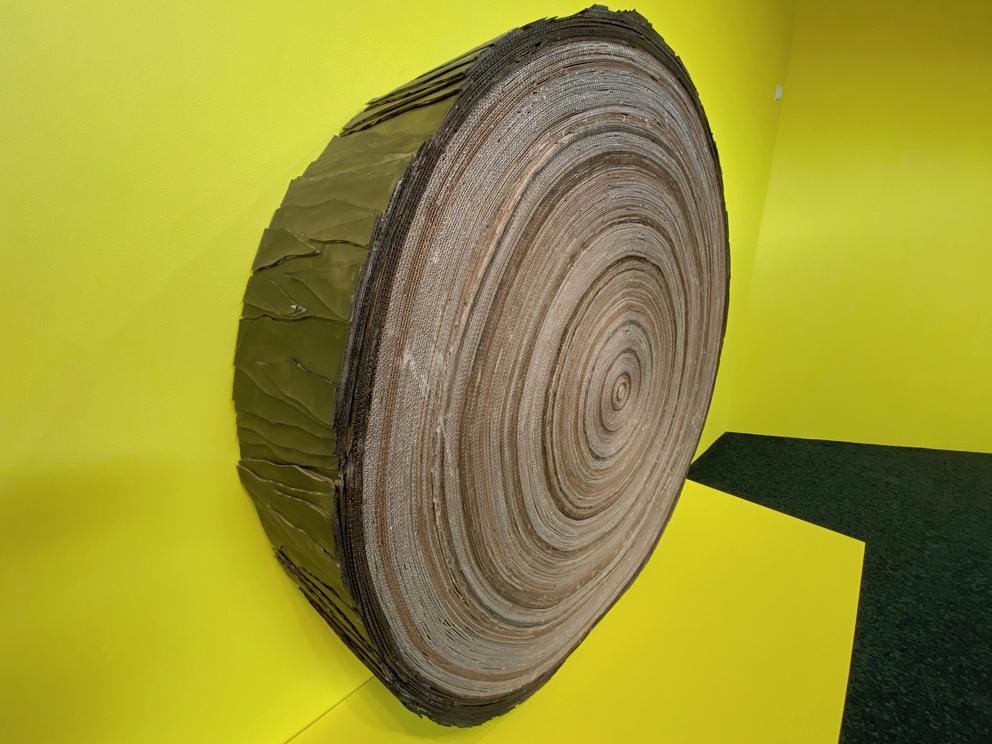 a log made out of cardboard on yellow background