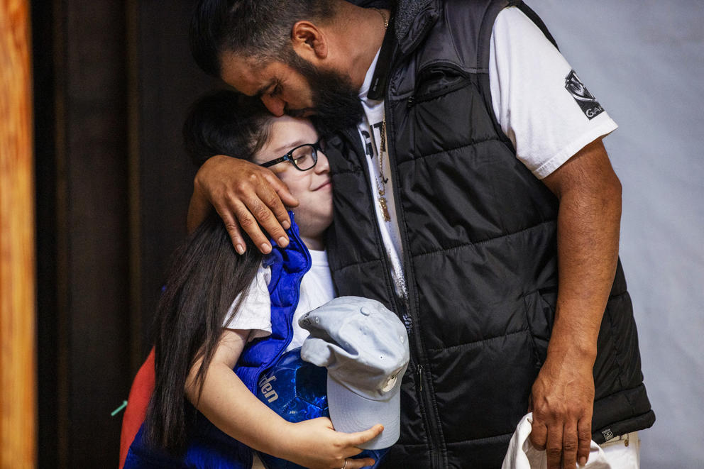 Jose Robles kisses his nine-year-old daughter Natalie at Riverton Park United Methodist Church before marching to the ICE offices on July 17, 2019. The undocumented father of three was at risk of deportation and had been taking refuge at Gethsemane Lutheran Church in Seattle for a little over a year. On Wednesday, with a crowd of community support, Robles marched to ICE offices to request a stay of removal but was arrested instead. (Photo by Dorothy Edwards/Crosscut)