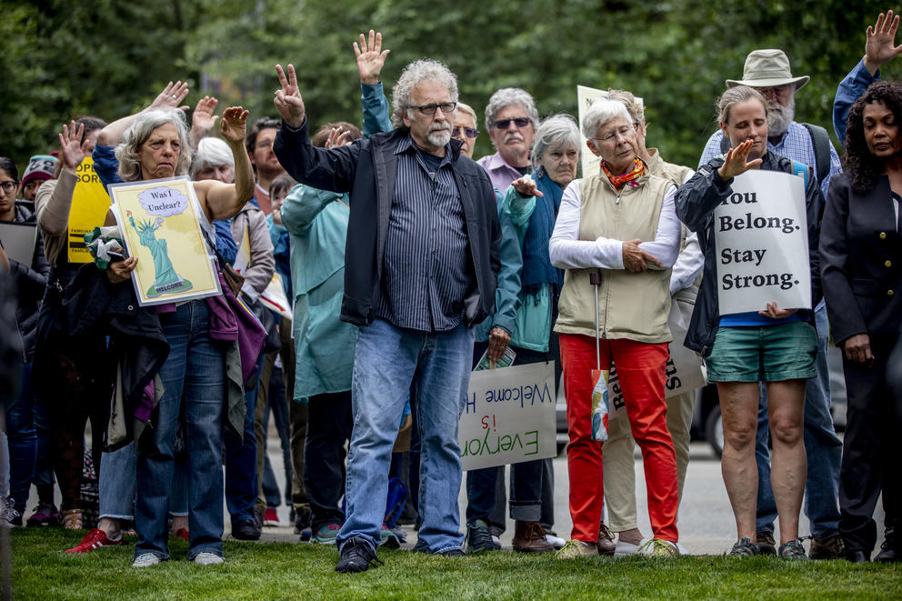 Community members and activists rally around Jose Robles outside of the ICE offices in Tukwila on July 17, 2019. The undocumented father of three requested a stay of removal but was arrested instead. (Photo by Dorothy Edwards/Crosscut)