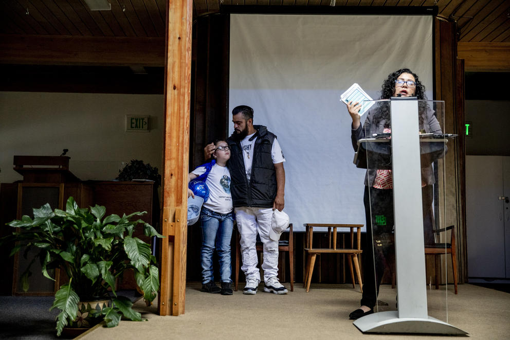 Jose Robles hugs his nine-year-old daughter Natalie at Riverton Park United Methodist Church during a press conference before marching to the ICE offices on July 17, 2019. (Photo by Dorothy Edwards/Crosscut)