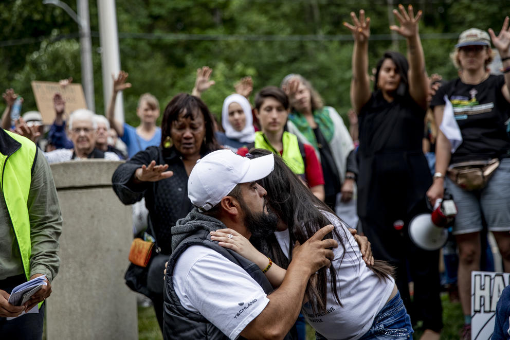 Community members and activists rally around Jose Robles as he says goodbye to his nine-year-old daughter Natalie outside of the ICE offices in Tukwila on July 17, 2019. The undocumented father of three requested a stay of removal but was arrested instead. (Photo by Dorothy Edwards/Crosscut)