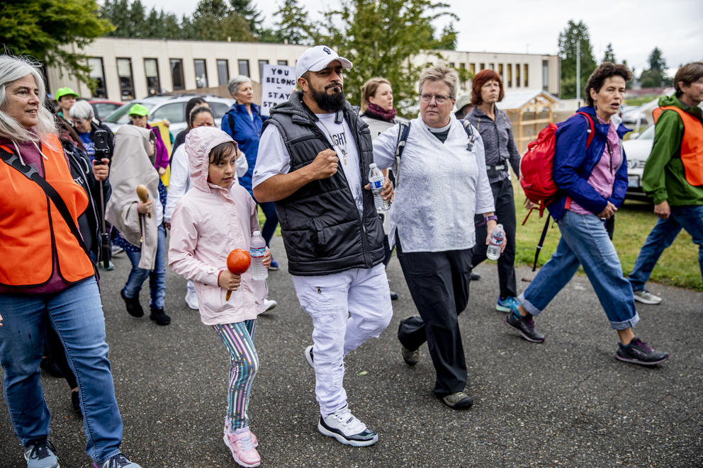 Community members and activists march with Jose Robles to the ICE offices in Tukwila on July 17, 2019. The undocumented father of three requested a stay of removal but was arrested instead. (Photo by Dorothy Edwards/Crosscut)