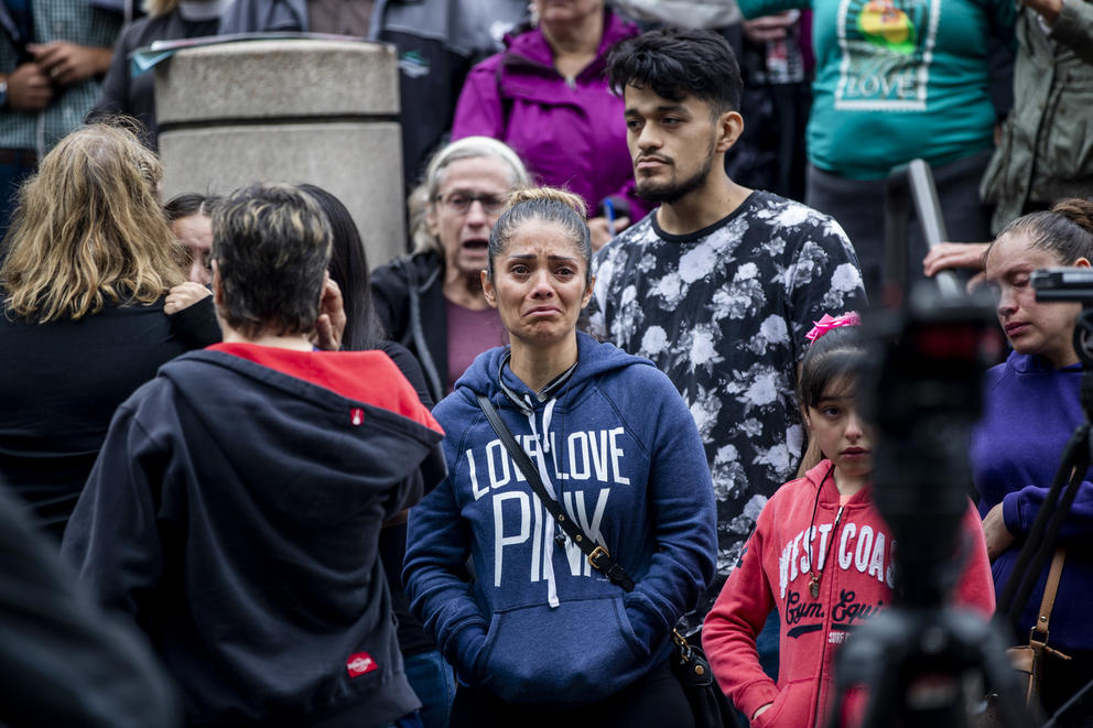 Jose Robles’ sister Rocio watches as her brother walks in to the ICE offices in Tukwila on July 17, 2019. The undocumented father of three was at risk of deportation and had been taking refuge at Gethsemane Lutheran Church in Seattle for a little over a year. On Wednesday, with a crowd of community support, Robles marched to ICE offices to request a stay of removal but was arrested instead. (Photo by Dorothy Edwards/Crosscut)