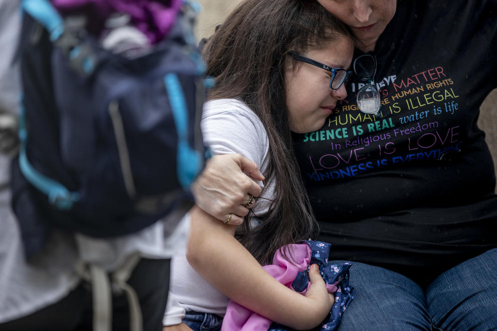 Jose Robles’ daughter, Natalie, 9, is embraced after she learns that Robles had been detained by ICE in Tukwila on July 17, 2019. Robles went to the ICE offices to request a stay of removal but was arrested instead. (Photo by Dorothy Edwards/Crosscut)