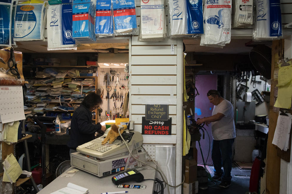 Employee Ogie Estrella and co-owner Guy McNally work on various vacuums at The Vac Shop in Seattle's Georgetown neighborhood, Nov. 16, 2018.