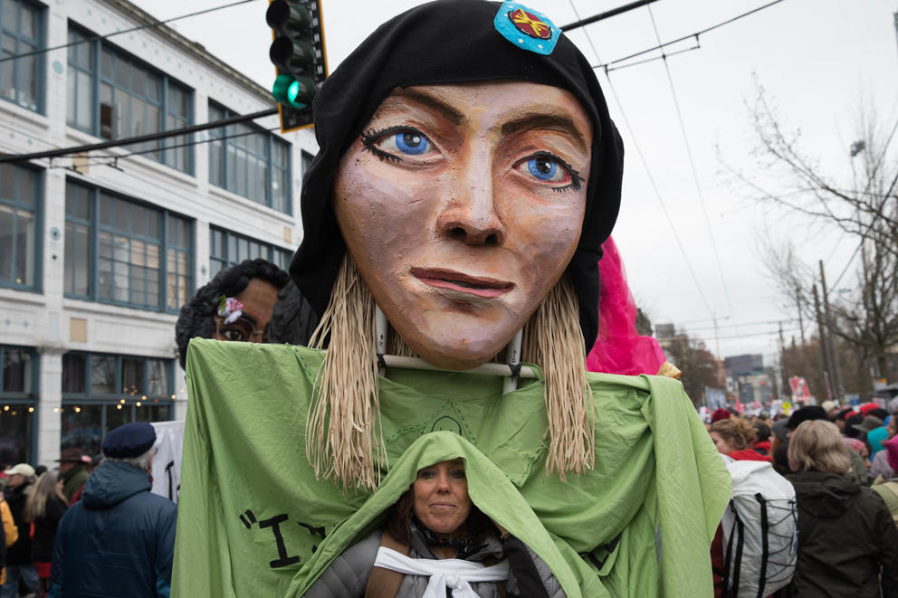 Laura Yacko of Seattle wears a large Chelsea Manning puppet above her head during the Seattle Women’s March 2.0 in Seattle, Jan. 20, 2018.
