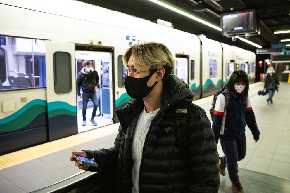 Zulkifli Sales wears a face mask while walking on a light rail platform
