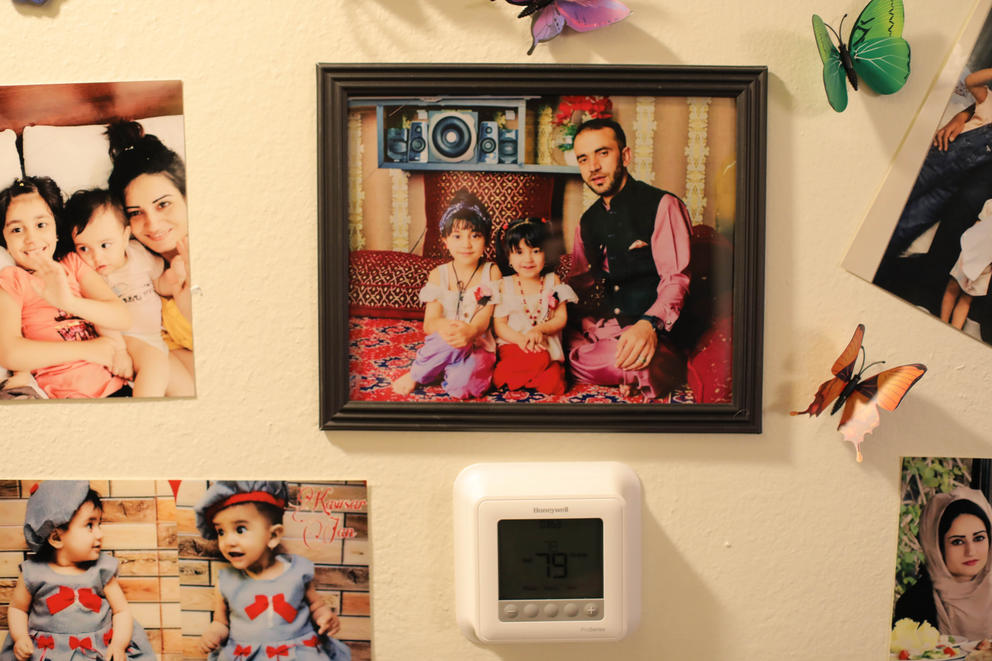 A framed photo of Reshad Al Noori and two of his daughters in traditional dress hangs on the wall.